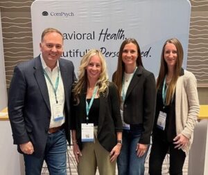 group of people posing at a corporate event