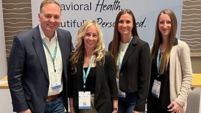 group of people posing at a corporate event