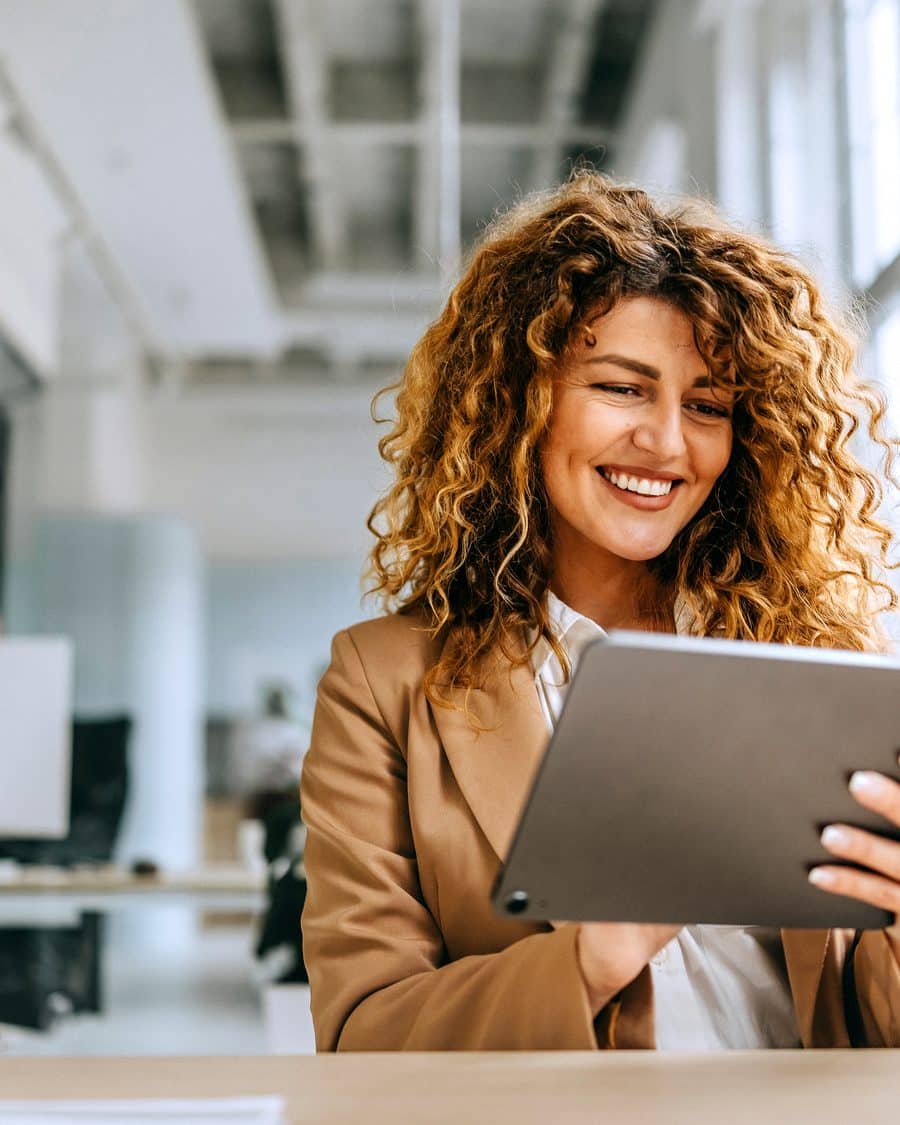 HR leader reviewing global benefits on a tablet